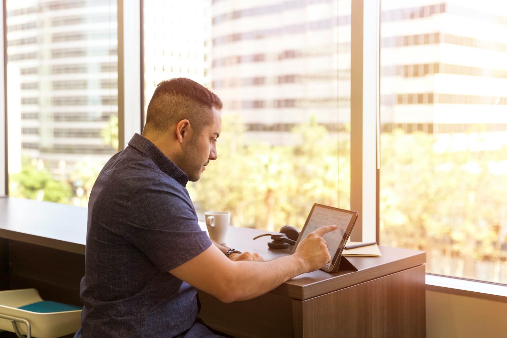 businessman works on tablet