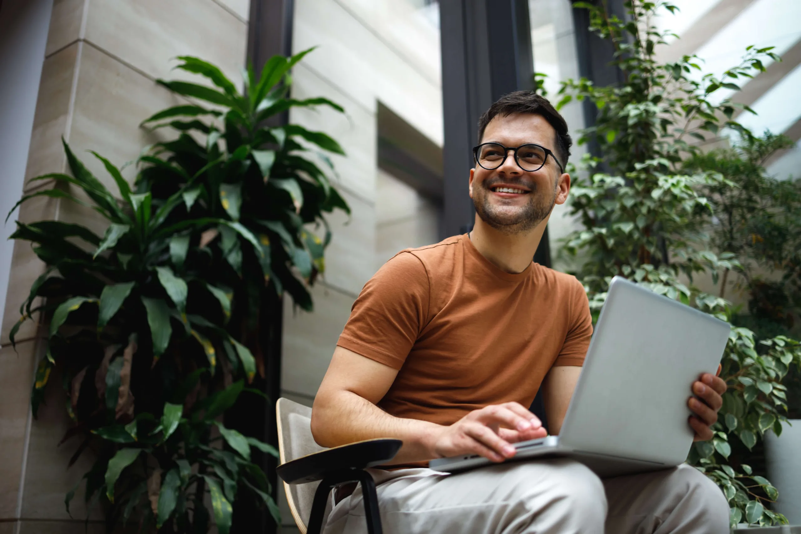 employee with laptop in office lobby