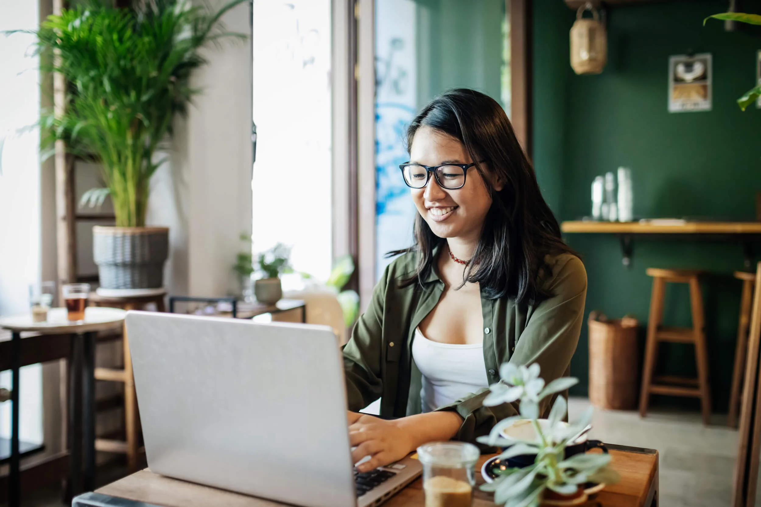 smiling person working on laptop